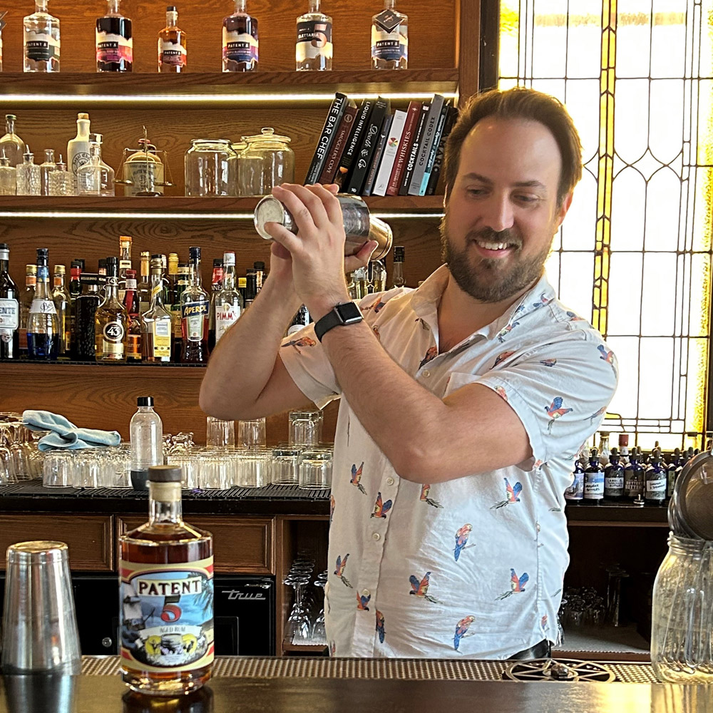 A Patent 5 Bartender makes a rum cocktail.